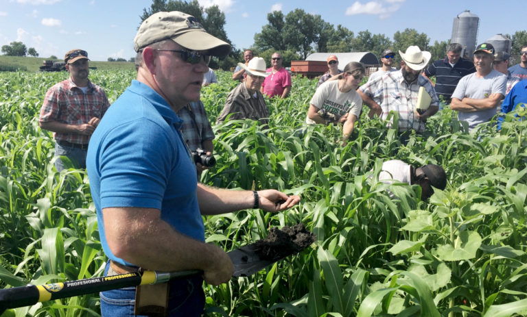Allen Williams in field with shovel during Dirt Rich workshops
